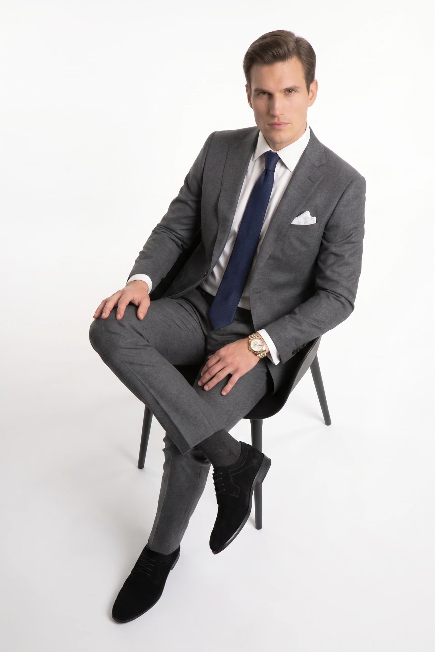 The same AI-styled charcoal grey suit look in a seated pose, generated with Alovia combine outfit
