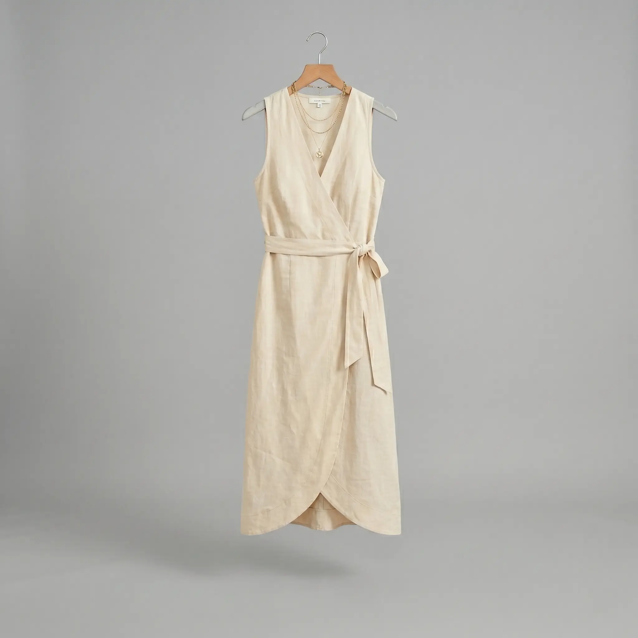 Photorealistic AI fashion model generated by Alovia on a Santorini beach, demonstrating fabric-consistent drape and summer collection detailing.